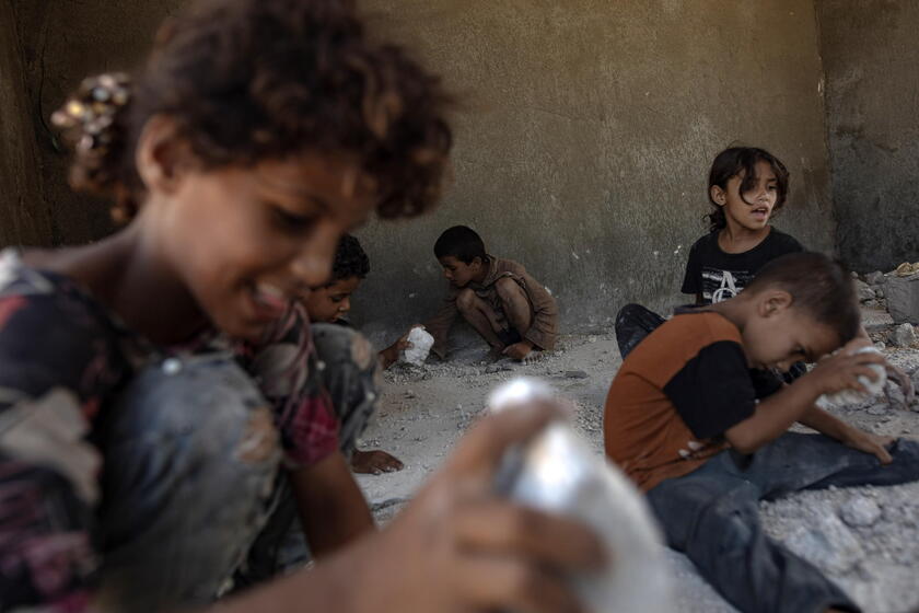 Palestinians make graves from the rubble of Gaza's destroyed homes