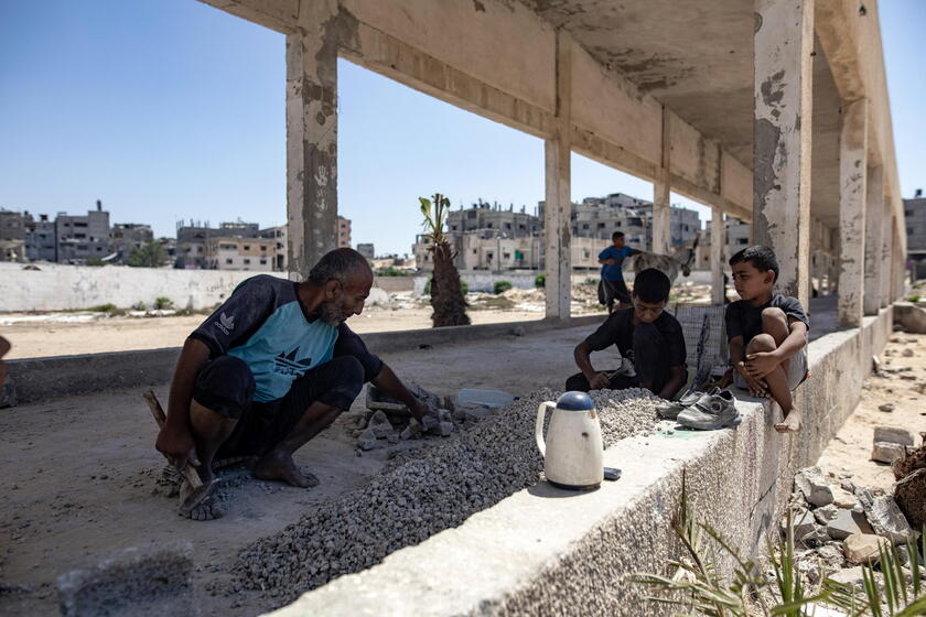 Palestinians make graves from the rubble of Gaza's destroyed homes