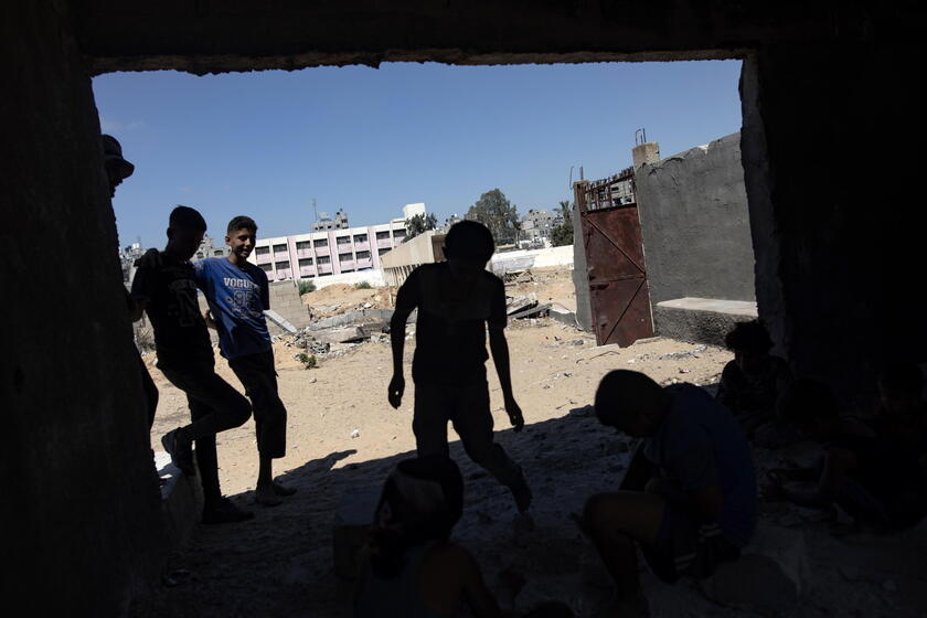 Palestinians make graves from the rubble of Gaza's destroyed homes